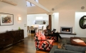 a living room filled with furniture and a flat screen tv