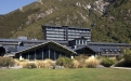 a large building with a mountain in the background