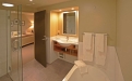 a large white tub sitting next to a sink