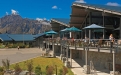 a large building with a mountain in the background