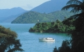 a small boat in a body of water with a mountain in the background