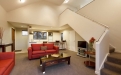 a living room filled with furniture and a flat screen tv