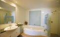 a large white tub sitting next to a sink