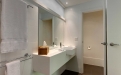 a white sink sitting under a mirror next to a shower