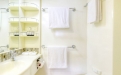 a white tub sitting next to a sink