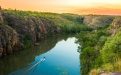 a close up of a hillside next to a body of water