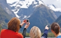 a man and a woman standing in front of a mountain