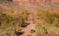 a car driving down a dirt road