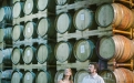 a group of people standing in front of a barrel