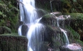 a large waterfall over some water