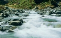 a large waterfall over a rocky cliff