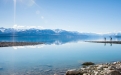 a large body of water with a mountain in the background