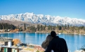 a large body of water with a mountain in the background