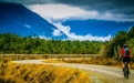 a person riding a bike down a dirt road