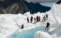 a group of people riding skis on top of a snow covered mountain