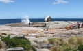 a rocky beach next to a body of water