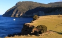 a body of water with a mountain in the background