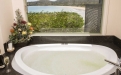 a large white tub sitting next to a sink