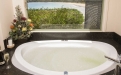 a large white tub sitting next to a sink