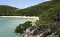 a rocky island in the middle of a body of water