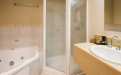 a large white tub sitting next to a sink