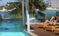 a person sitting in a chair next to a pool of water