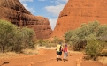 a group of people walking in front of a canyon