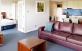 a living room filled with furniture and a flat screen tv