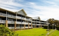 a large building with a grassy field