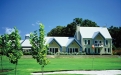 a house on top of a lush green field