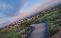 a wooden bench on the side of a hill