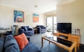 a living room filled with furniture and a flat screen tv