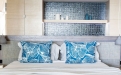 a blue and white bed in a room