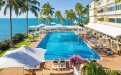 a group of palm trees next to a pool of water