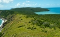 a close up of a hillside next to a body of water