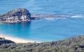 a body of water with a mountain in the background