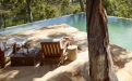 a wooden bench sitting next to a body of water