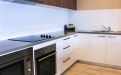 a kitchen with a white microwave oven sitting on top of a stove
