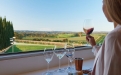 a person sitting at a table with wine glasses