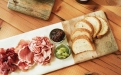 a plate of food sitting on top of a wooden cutting board