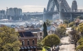 a bridge over a river with a city in the background