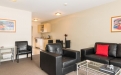 a living room filled with furniture and a flat screen tv