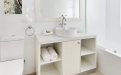 a white sink sitting under a window