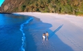 a person standing next to a body of water