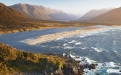 a body of water with a mountain in the background