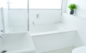 a white tub sitting next to a window