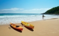 a yellow boat sitting on top of a sandy beach