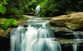 a large waterfall over some water