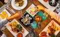 a group of people sitting at a table with a plate of food