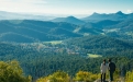 a man standing in front of a mountain